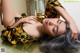 A woman laying on top of a table with her eyes closed.